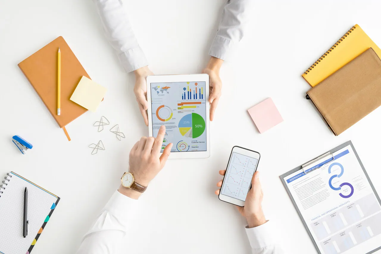 view-of-hands-of-analysts-or-brokers-with-gadgets-2023-11-27-04-56-49-utc